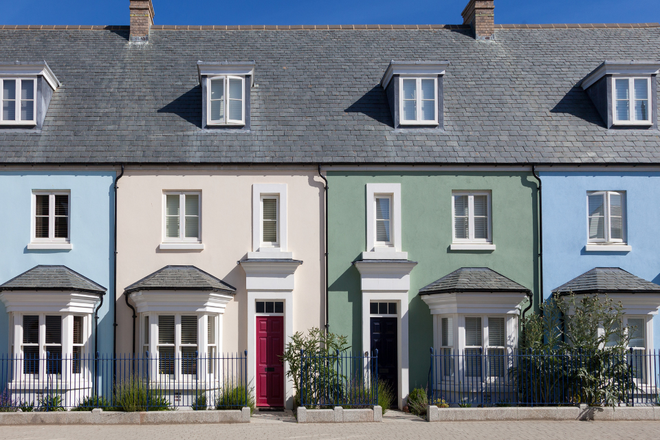 A row of modern pastel terraced houses