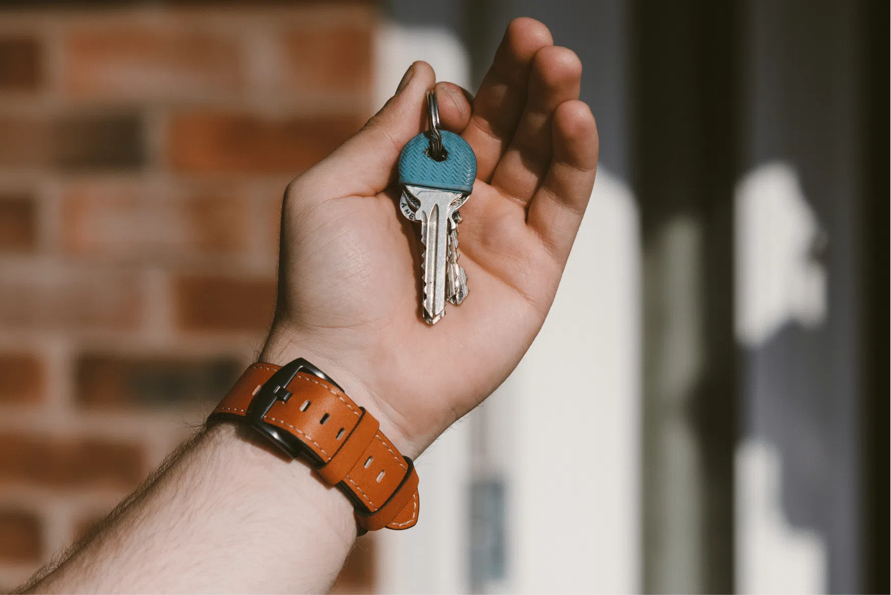 Keys being handed over at a front door